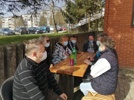 Na fotografiji skupina ljudi sjedi ispred Dnevnog centra slijepih.