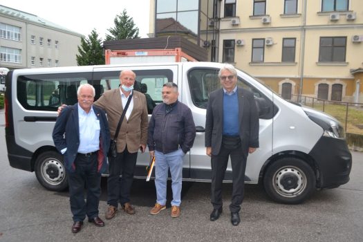 Na fotografiji se nalaze četiri muške osobe koje stoje pored kombi vozila Udruge u krugu sisačke bolnice.